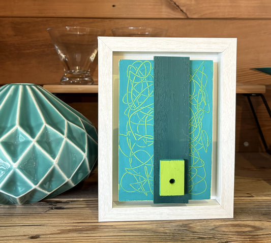 Mini Musings - Big Teal by Nancy Benoy. Framed abstract art piece with colorful geometric shapes on an orange background . Nancy Benoy is a featured artist for SOCIAL SPACE I Holiday Market at MRKT Box - Strathcona Market location from November 14 - 16,2025.