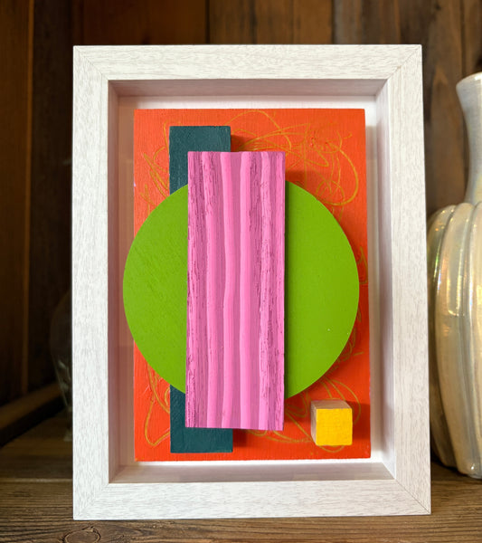 Mini Musings - Pretty Hottie by Nancy Benoy. Framed abstract art piece with colorful geometric shapes on an orange background . Nancy Benoy is a featured artist for SOCIAL SPACE I Holiday Market at MRKT Box - Strathcona Market location from November 14 - 16,2025.