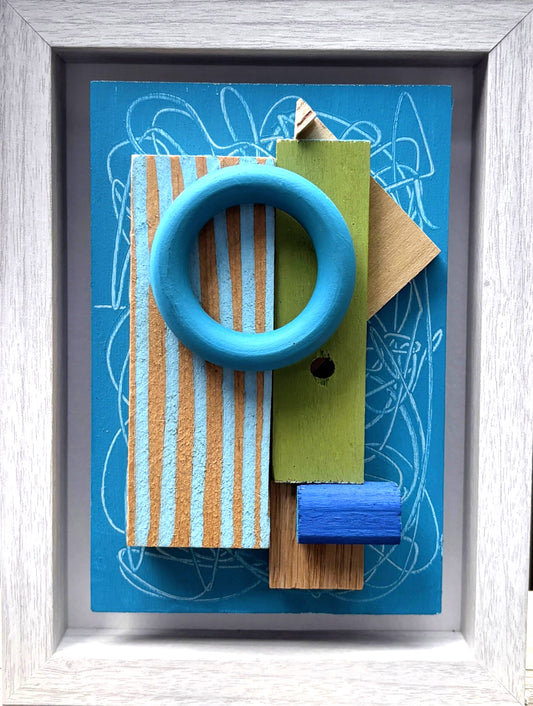 Mini Musing - Blue by Nancy Benoy  - A Colorful geometric wall sculpture of shapes on a blue background with a white frame. Nancy Benoy is a featured artist for SOCIAL SPACE I Holiday Market at MRKT Box - Strathcona Market location from November 14 - 16,2025.
