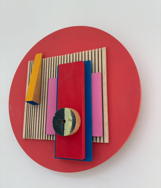 Red Hot by Nancy Benoy  - A Colorful geometric wall sculpture of shapes on a red background . Nancy Benoy is a featured artist for SOCIAL SPACE I Holiday Market at MRKT Box - Strathcona Market location from November 14 - 16,2025.